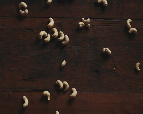 garlic cloves scattered on a rustic wooden kitchen table